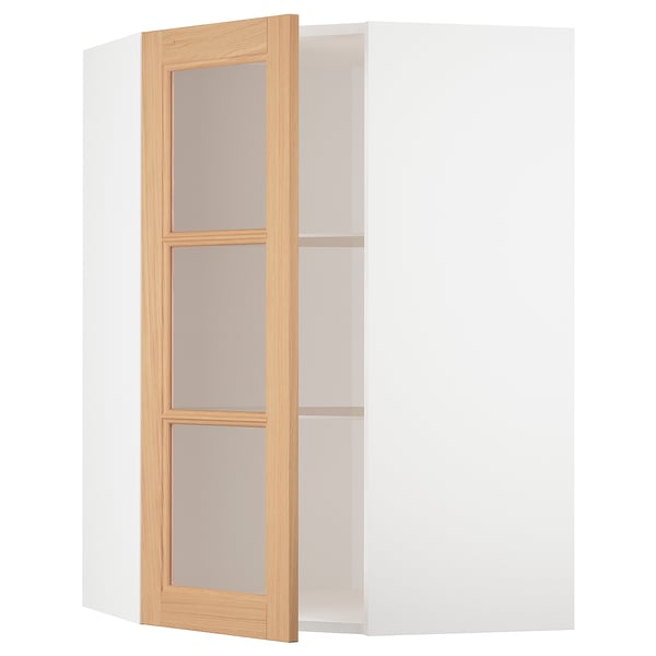 An open white corner cabinet with a wooden door, featuring glass shelves.