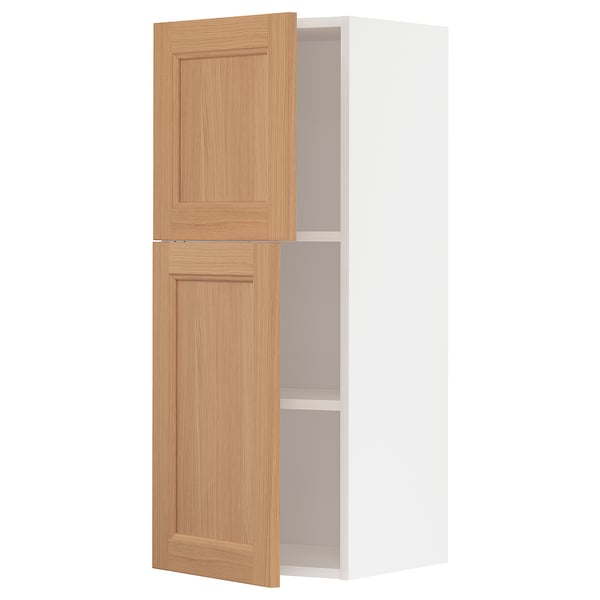 White tall kitchen cabinet with two oak doors and shelves.