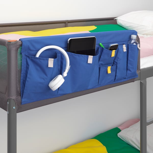 Blue bed pocket organiser holds phone, headphones, water bottle on bunk bed.
