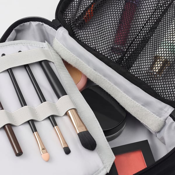 Makeup bag with brushes and cosmetics; two compartments, one with mesh; high-quality, organised.