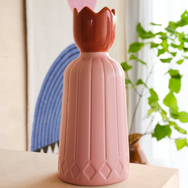 Pink ceramic candle holder with diamond base and fluted top.