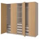 A wooden PAX wardrobe with open doors displaying shelves, drawers, and compartments.