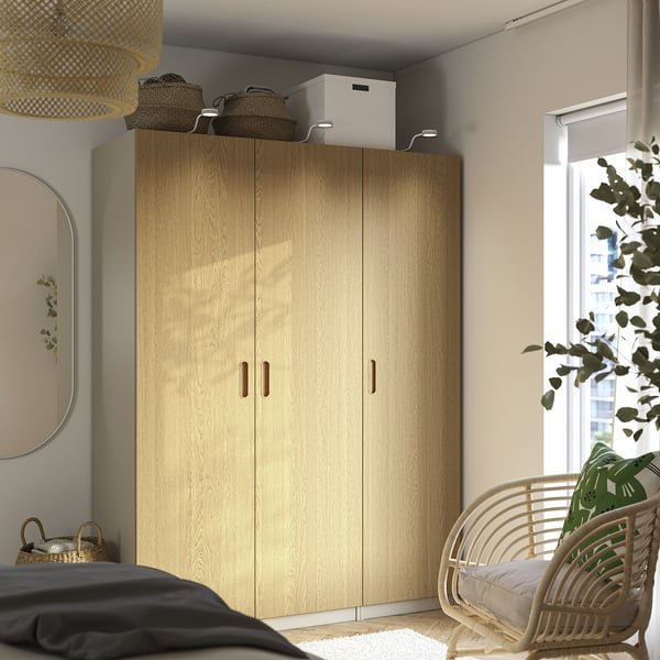 PAX wardrobe with baskets, mirror, chair, plant