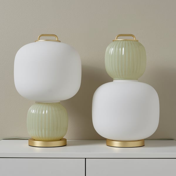Two stylish lamps with frosted glass and gold bases. One white, one light green shade.