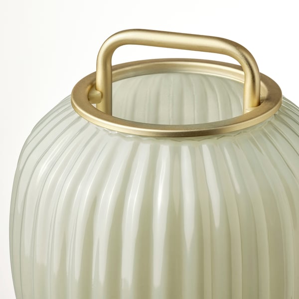 Frosted glass lamp with gold handle, elegant design.