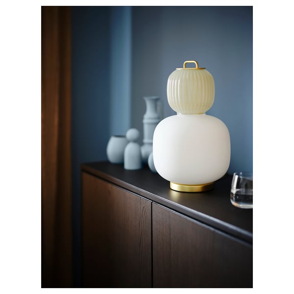Unique lamp with yellow and white glass, gold base, resembling traditional lanterns. Perfect for decorative lighting.