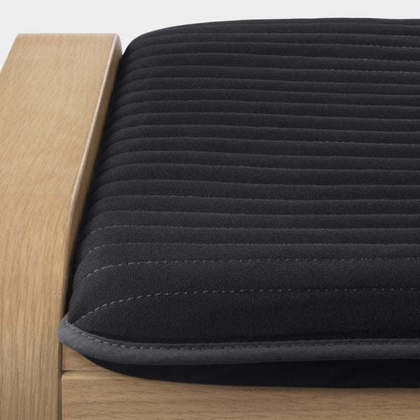 Covered stool, dark cloth, horizontal lines, wooden edge.
