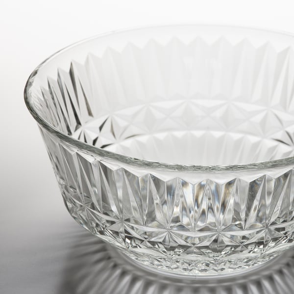 Intricate cut glass bowl, reflective of light, finely detailed.