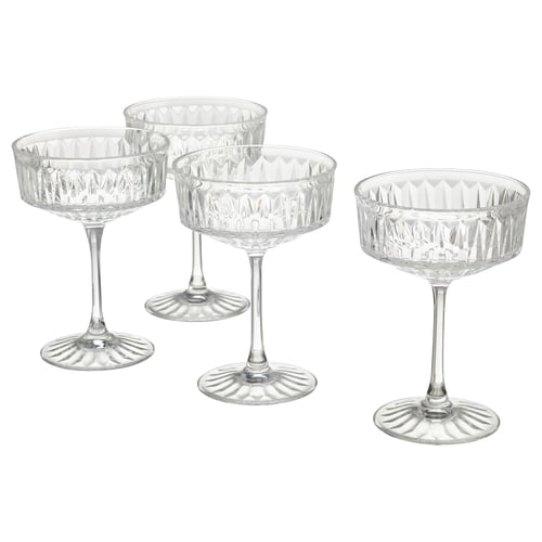 Four elegant, clear glass coupes with diamond patterns, standing upright for champagne or cocktails.
