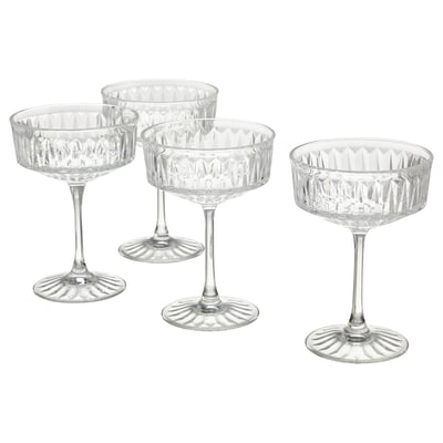 Four elegant, clear glass coupes with diamond patterns, standing upright for champagne or cocktails.