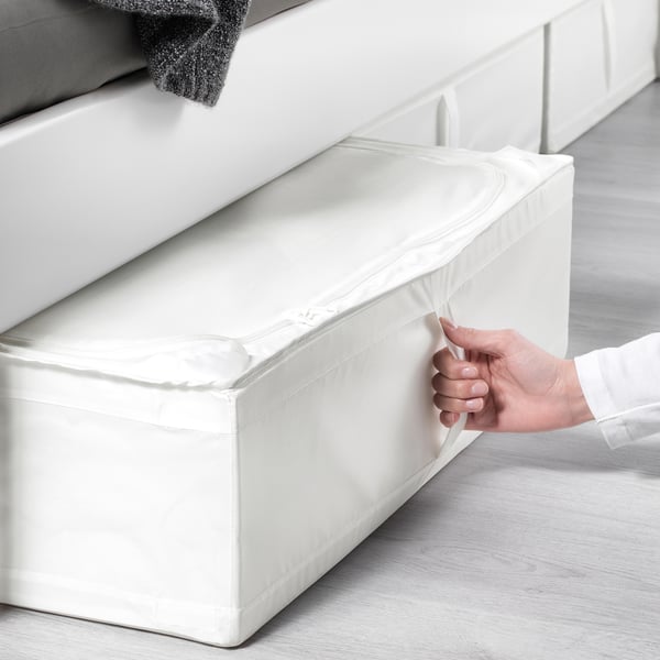 Person pulling white storage case under bed; ideal for seasonal items and dust protection.