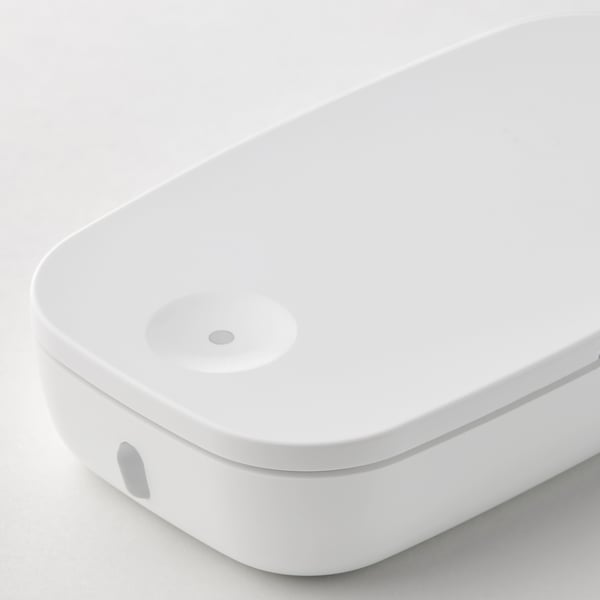 Sleek, modern white smart remote control with round button, placed on a plain background.