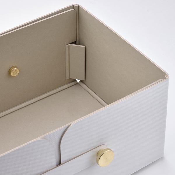 Paper storage box with gold accents. Removable top with compartments, stylish for organising small items.