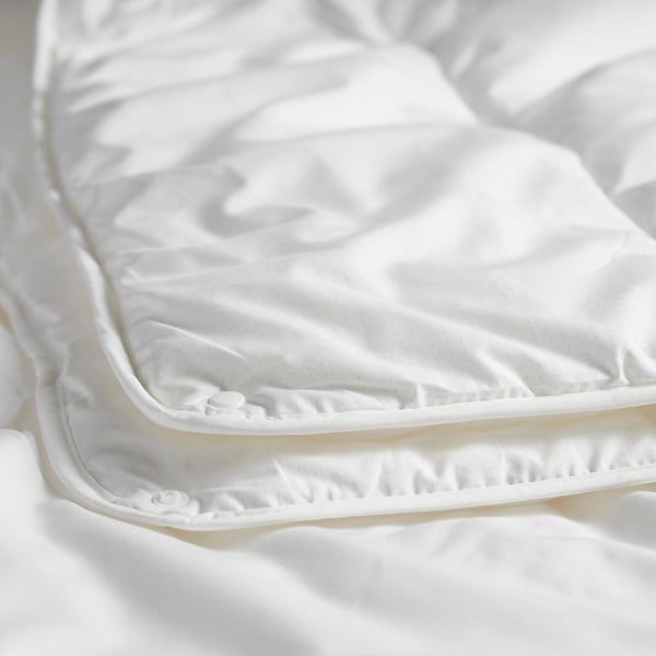 Close-up of quality white duvet with smooth fabric, detailed stitching, and soft texture.