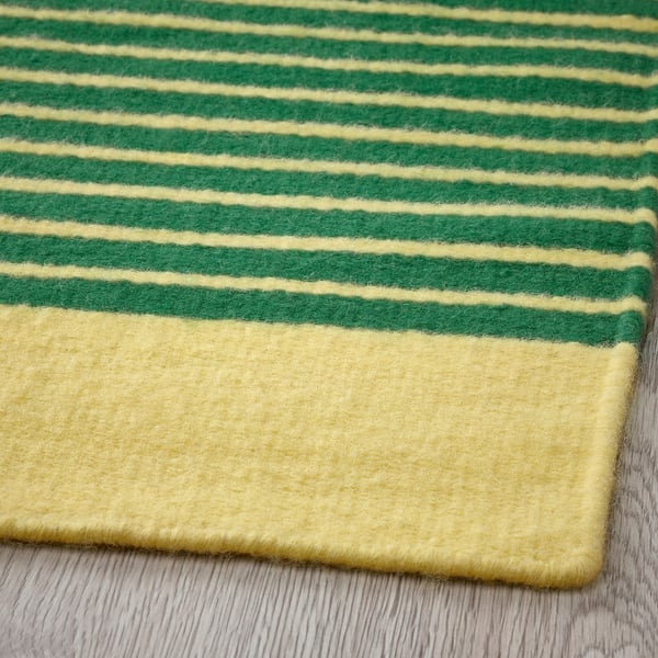 Striped rug, vibrant yellow and green stripes, soft wool texture, handwoven craftsmanship.
