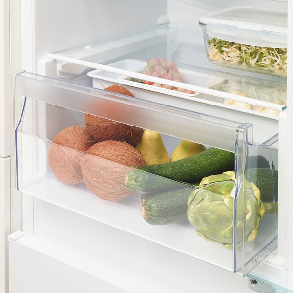 Fridge drawer with adjustable divider stores diverse produce.