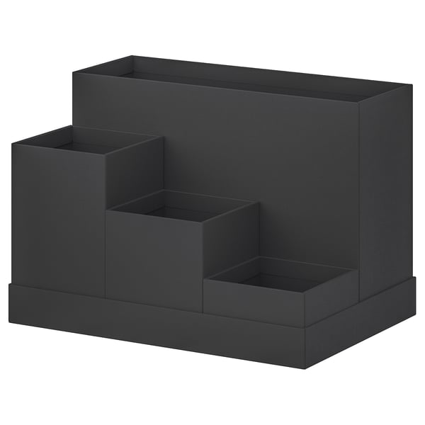 A black TJENA desk organiser with multiple compartments for storage. Its made of recycled paper and has a modern, minimalist design.
