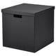 A TJENA box in black. Its square-shaped with a lid and handles, made from recycled paperboard.
