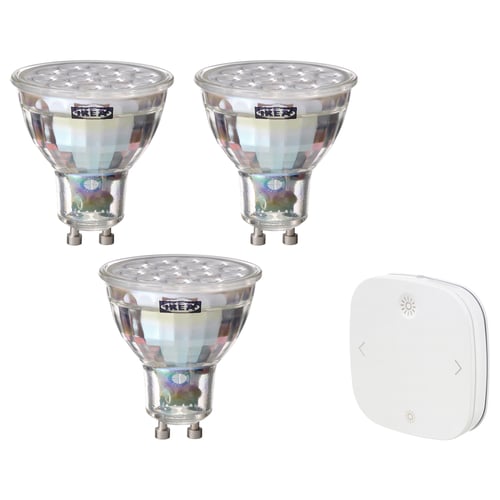 Three ikea TRÅDFRI smart bulbs with metallic finish and one white remote control.