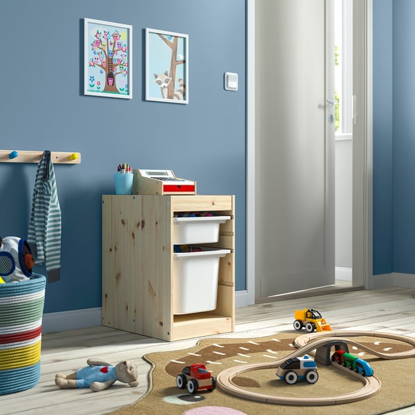 Childs playroom with TROFAST light wood storage, colourful toys, & blue walls.