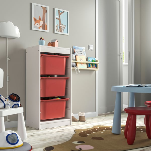 Kids playroom with white TROFAST storage & red bins for toys, bright & organised.
