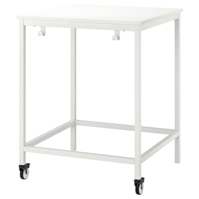 A white TROTTEN meeting table with four wheels. It has a rectangular shape and a smooth tabletop. Two hooks are on the side for hanging items.
