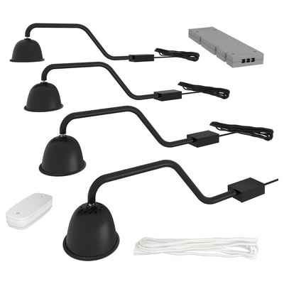 A black TVÄRDRAG lamp kit for cabinet lighting, including four curved arms with domed lamps, a power supply, and a wireless dimmer.