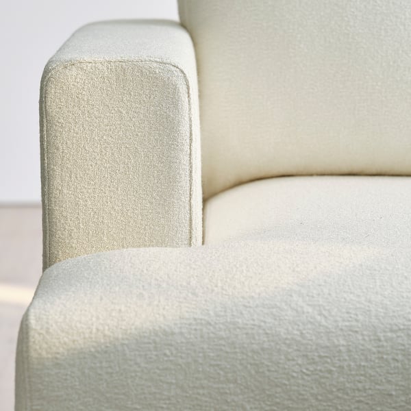 Close-up of UPPÅKRA sofa, soft, textured bouclé fabric, clean design, and sturdy build.