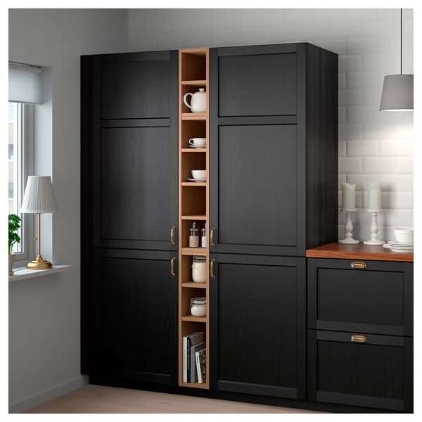 VADHOLMA black storage cabinet with dark wood & open compartment against white wall, lit by lamp.