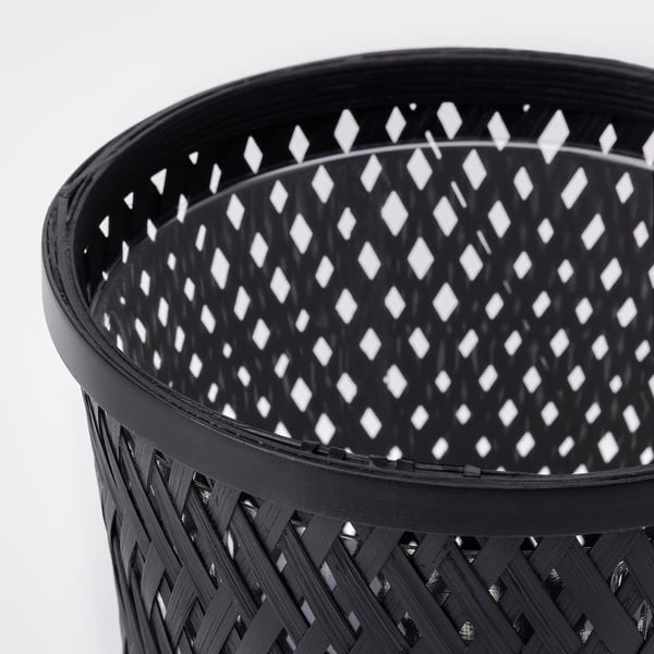 Black woven bamboo plant basket. Intricate, handmade, sustainable design.