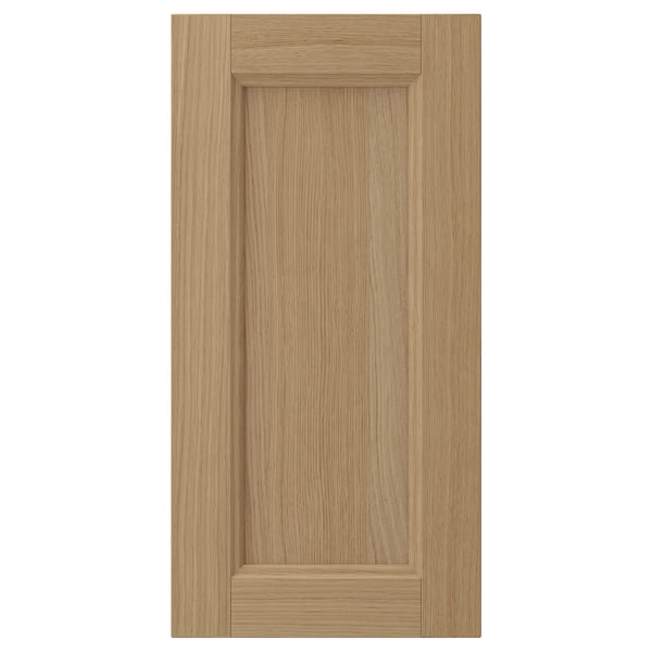 VEDHAMN natural oak cabinet door, rectangular with a sturdy frame and veneer panel. A light wood tone with a smooth, slightly textured finish.