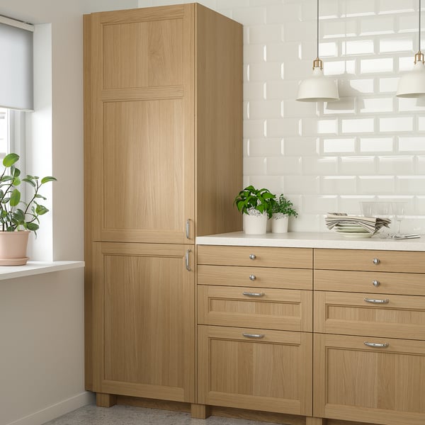 Natural wood cabinet set, tall & base units, modern kitchen with potted plants, light countertop.