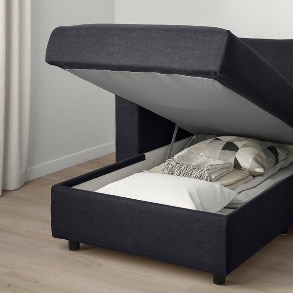 Black sofa with storage under seat, lid stays open, removable washable cover.