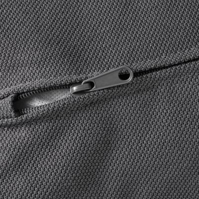 Close-up of a grey zip on a textured fabric sofa, showcasing high-quality materials and durable design.