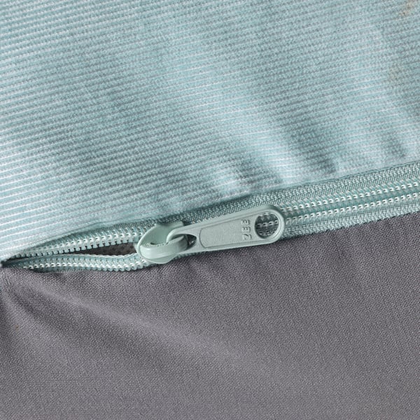 Zip detail of light grey, textured fabric sofa, focusing on quality design.