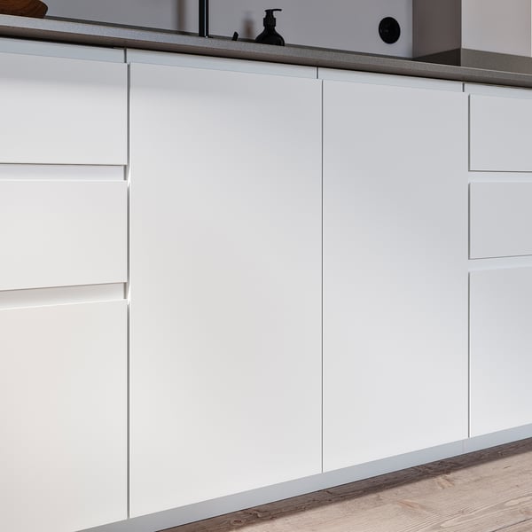 Modern white kitchen cabinets with minimalist integrated handles.