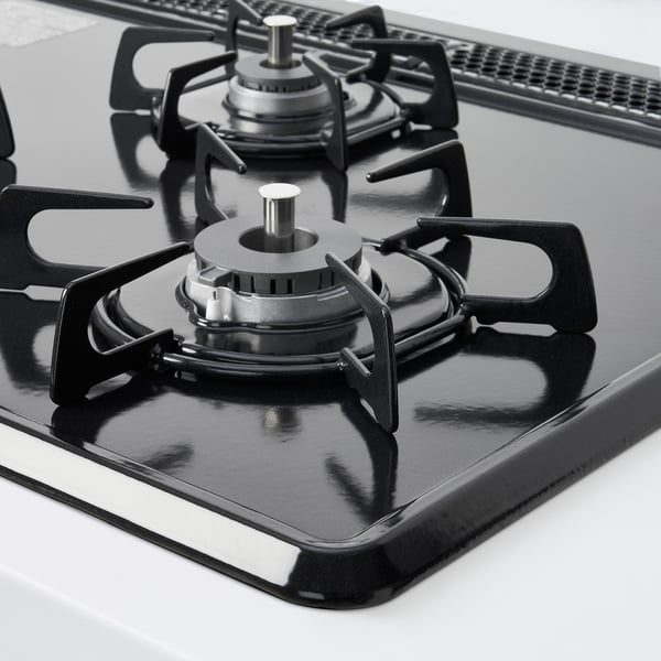 Black gas stove with three burners, featuring metallic burner caps and knobs, on a sleek modern cooktop.