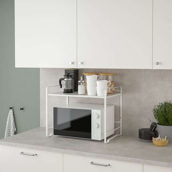 Kitchen counter with AVSTEG double shelf unit. Microwave and coffee maker are stored neatly, saving space and keeping the area tidy.
