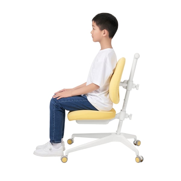 A young person sits in a yellow-and-white adjustable desk chair with wheels. The chair supports good posture and can be adjusted for height.