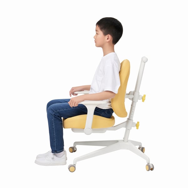Boyd seated in adjustable BERGLÄRKA desk chair, hands on lap, looking forward.