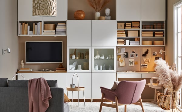 Modern living space with BESTÅ storage, white/light wood, glass, and shelves displaying tv, books, and decor.
