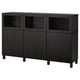 Black BESTÅ sideboard with glass doors, wooden frames, adjustable shelves.