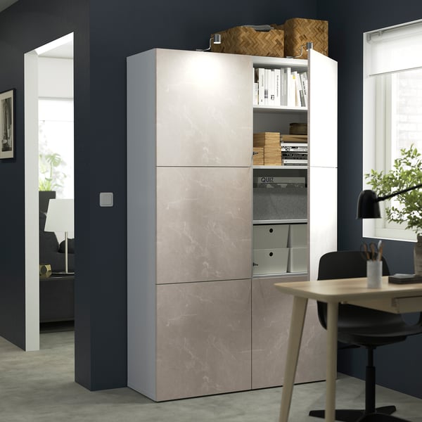 Modern office with BESTÅ storage unit featuring adjustable shelves and soft-closing doors, displaying books and organisational boxes.