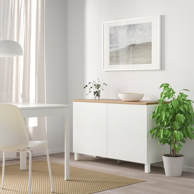 White BESTÅ furniture with adjustable shelves, decorative top.