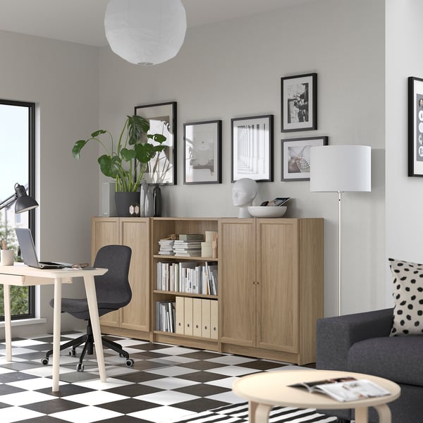 Home office with BILLY bookcase, desk, and couch.