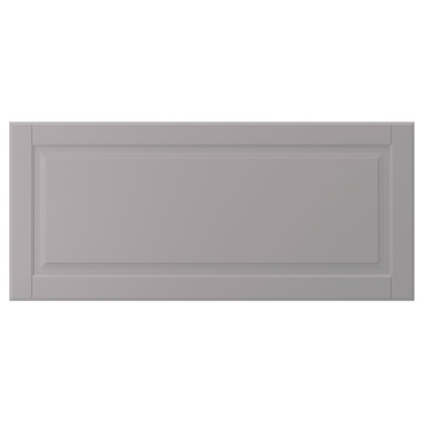 A grey, rectangular BODBYN cabinet door with bevelled panels, made of fibreboard.
