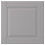 A soft grey BODBYN cabinet door with bevelled edges. Its square shape a classic panel design and smooth lacquered surface.