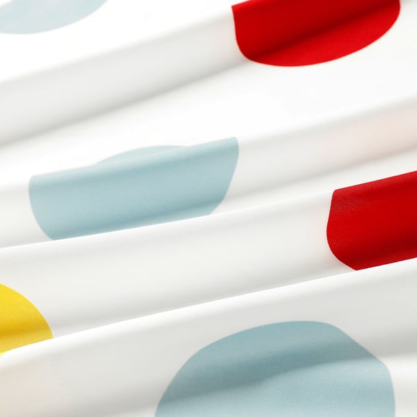 Abstract pattern of colourful, rounded shapes on white fabric. Soft texture, bright colours, modern design.
