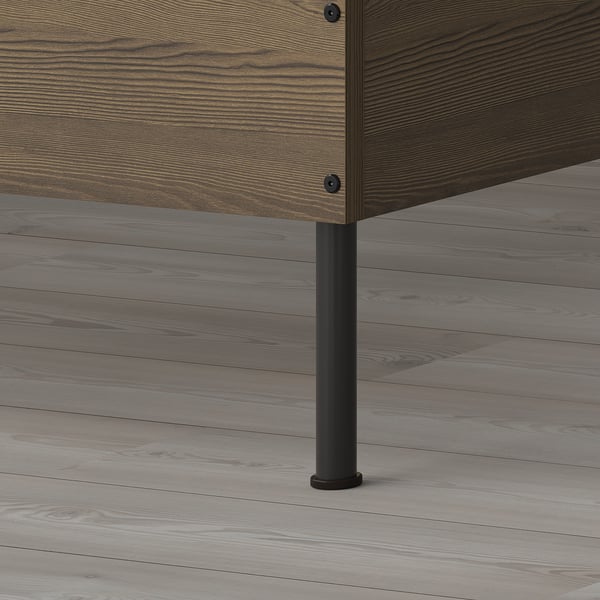 Close-up of sturdy bed frames metal leg, attached to wooden base, showing durable construction and stability.