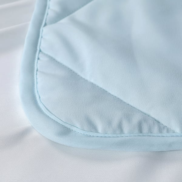 A close-up of a soft, light blue duvet with intricate stitching details, highlighting its quality and texture.